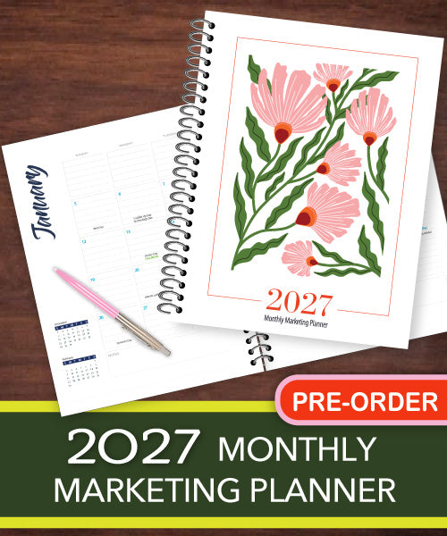 A 2027 monthly marketing planner shown open on a dark wood background, with the front cover displaying pink flowers and green leaves and the text '2027 Monthly Marketing Planner.' An interior page with a January calendar layout is visible underneath, along with a pink pen and a red 'PRE-ORDER' badge.
